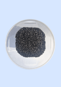 Basil seeds in a glass dish, small and black