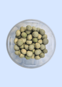 Green pea seeds in a glass dish, round and pale green