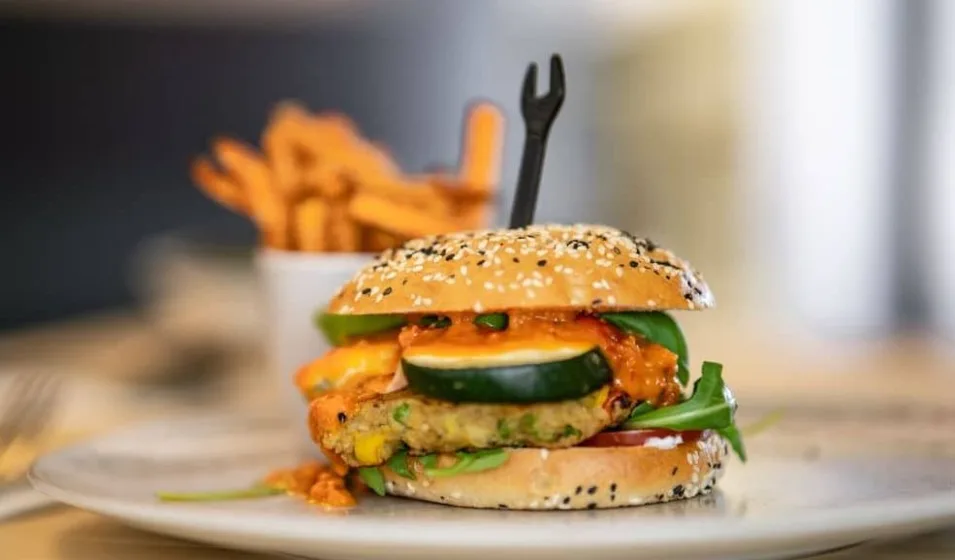 Vegetarian sweet potato burger topped with radish microgreens